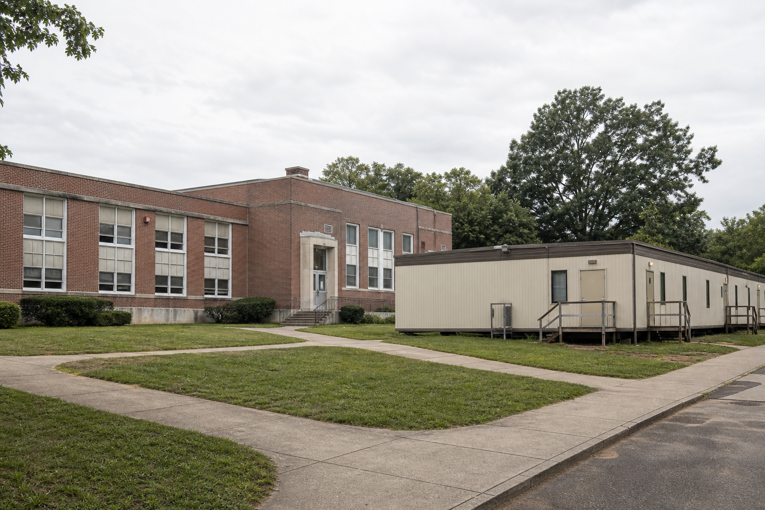 Illustrative view of an older school building with a modular classroom